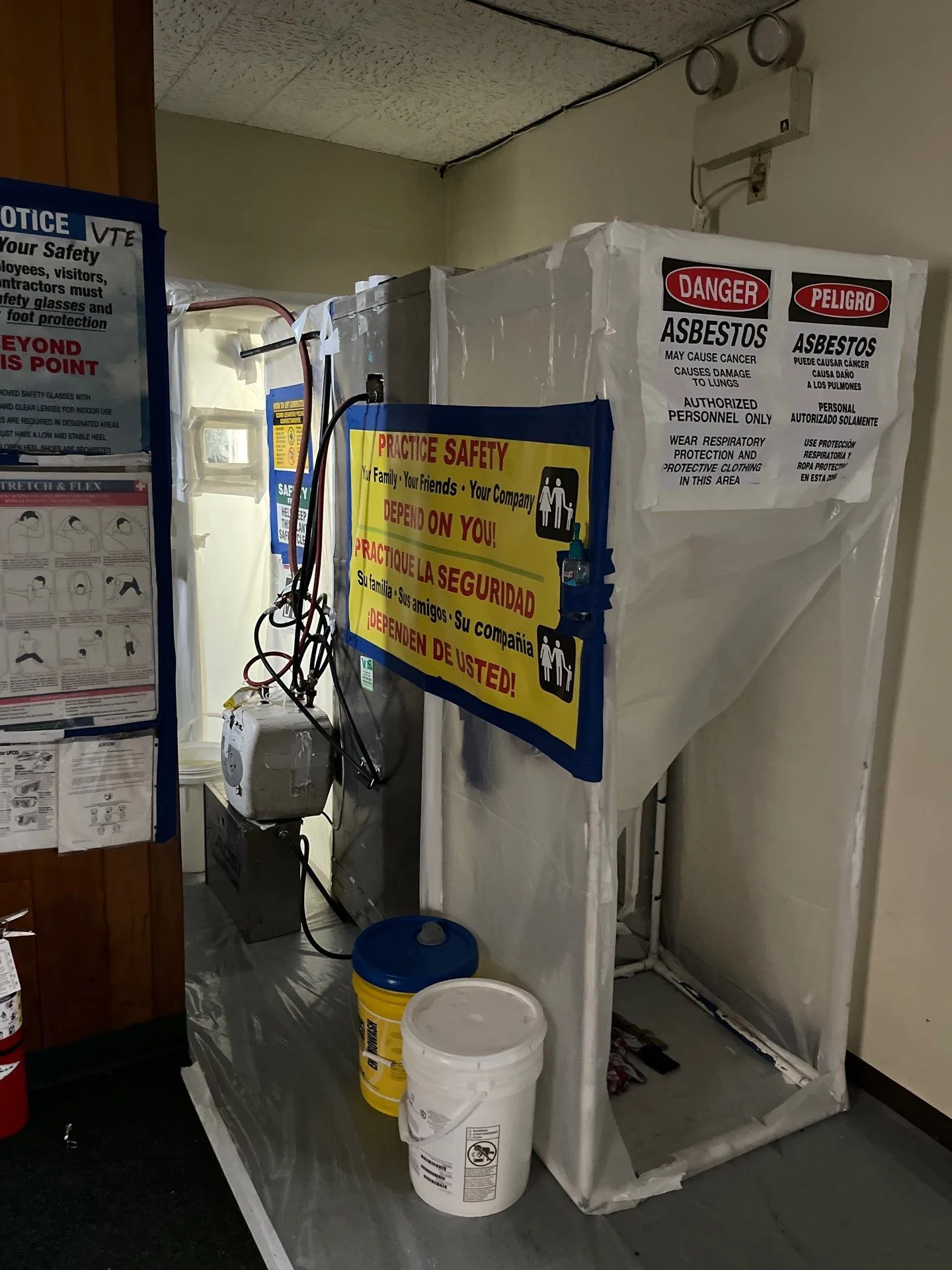 Asbestos containment entrance with safety signage