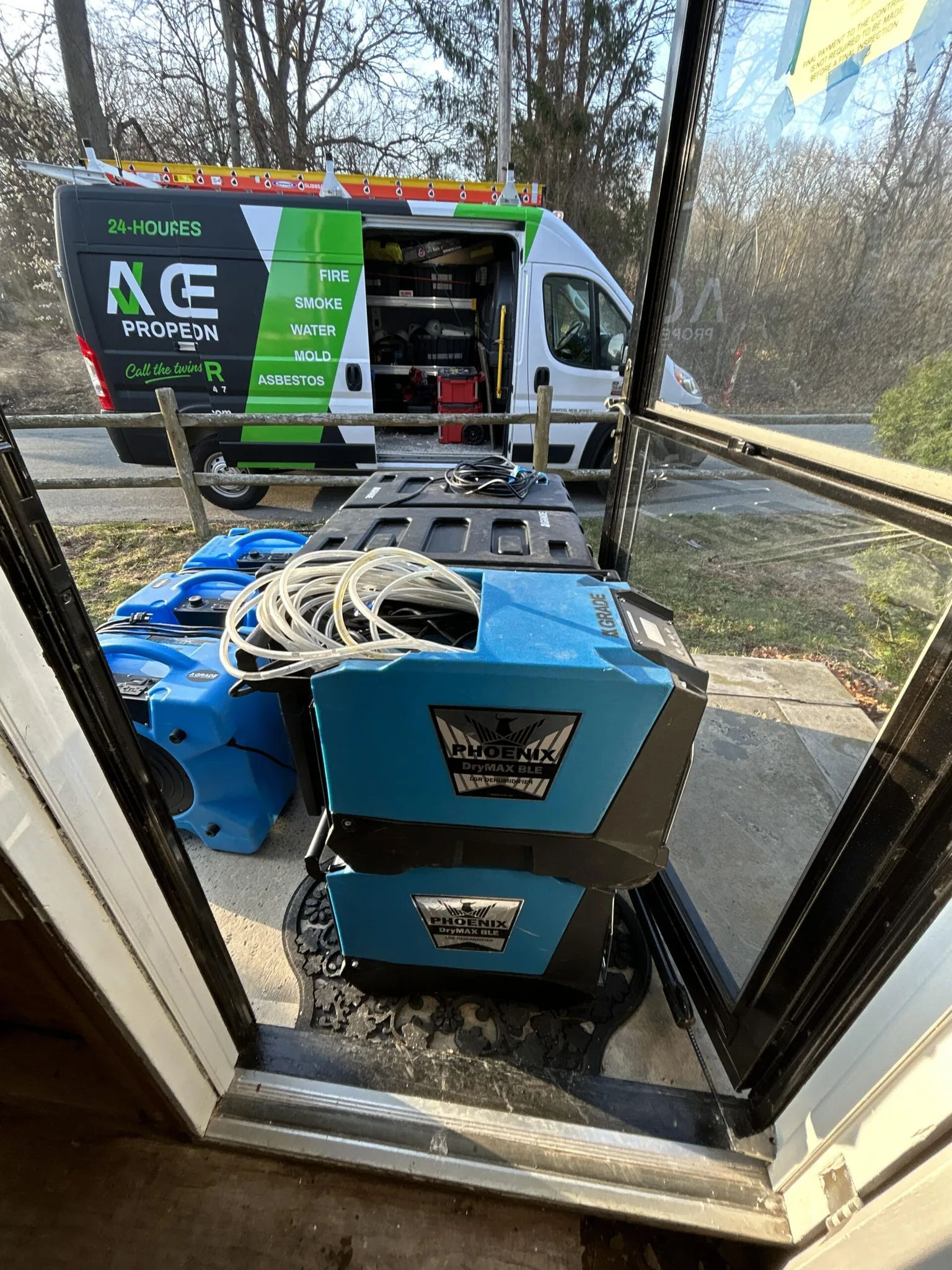 A GRADE water drying equipment staged at a property entrance