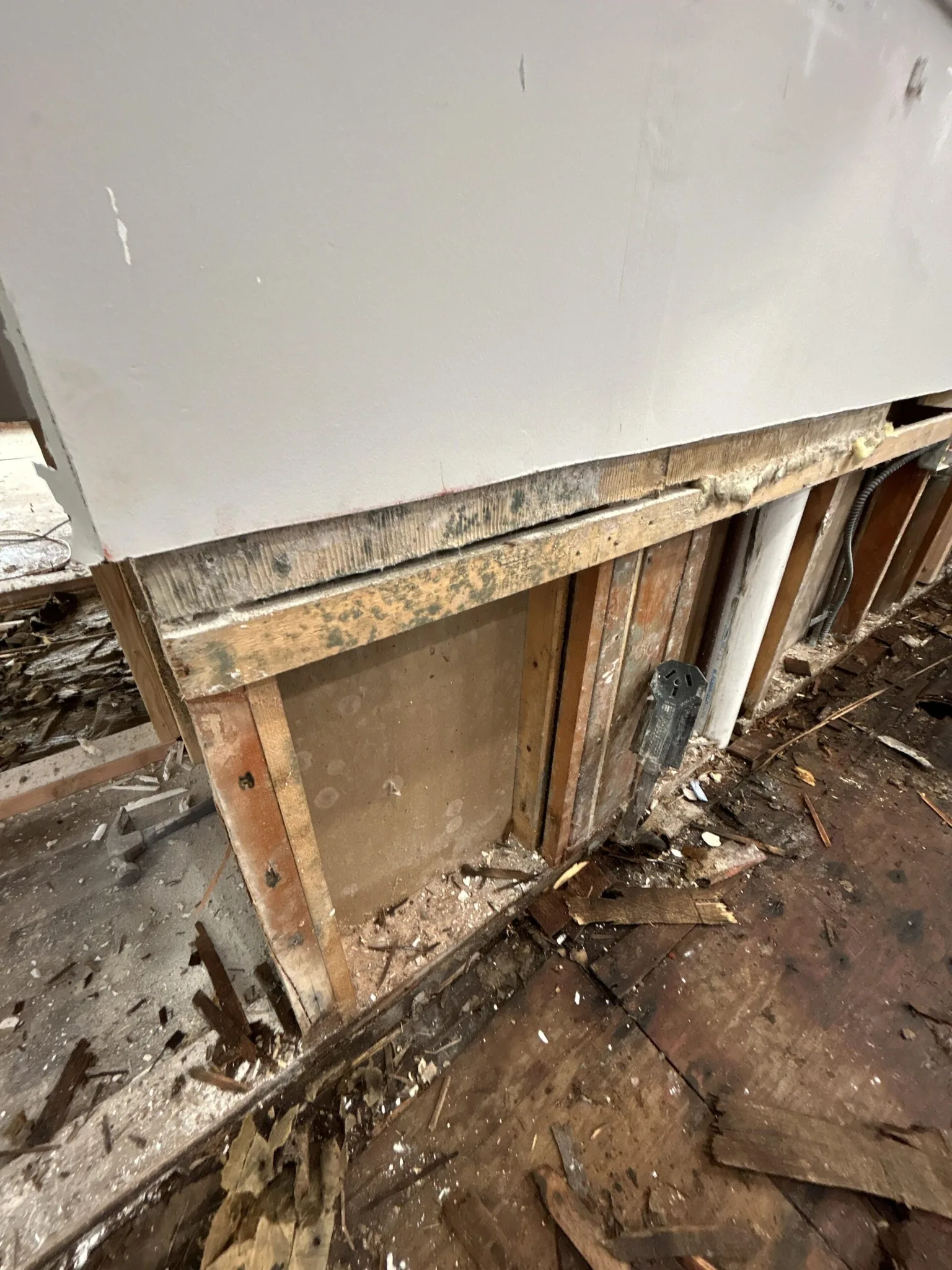 Wet flooring and lower wall removed so a water-damaged structure can dry